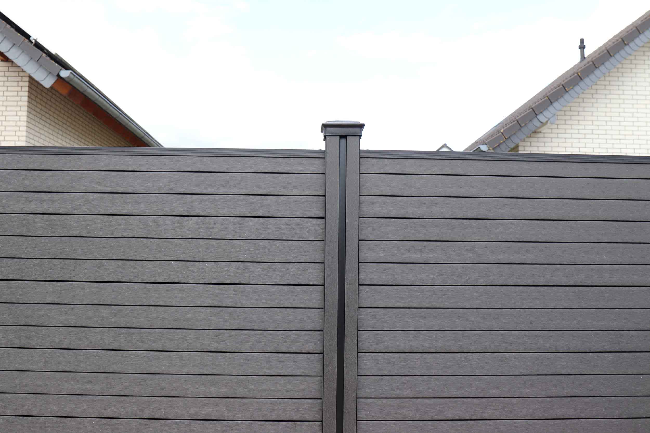 Gray wood fence post with horizontal boards.